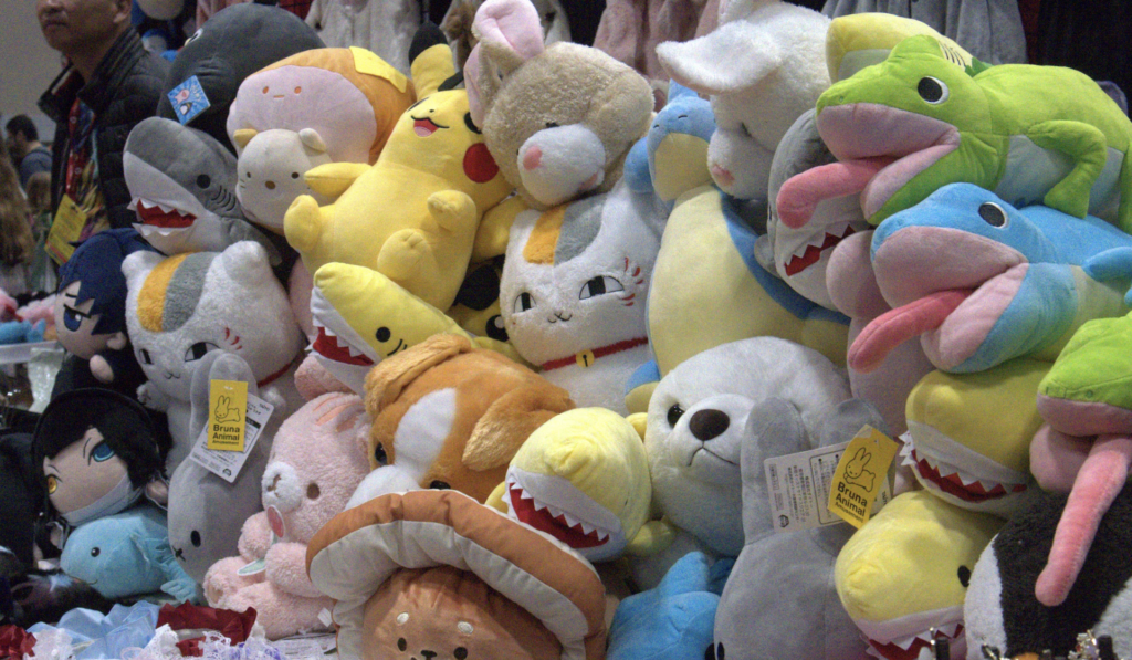 a wall of assorted anime and video game plushies.