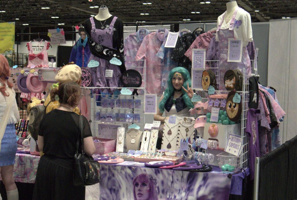a vendor selling cute lolita-style clothing while dressed as sailor neptune.
